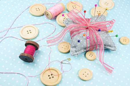 buttons on the table with pins and ribbons, Sewing accessories dressmakerの写真素材