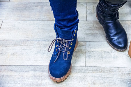 Cropped view of female legs in boots, Blue boot shoesの写真素材
