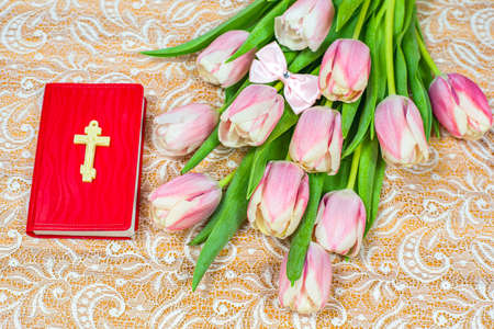 flowers and book on the table, background of religion Easter