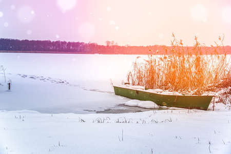 Winter Landscape with a fishing boatの写真素材