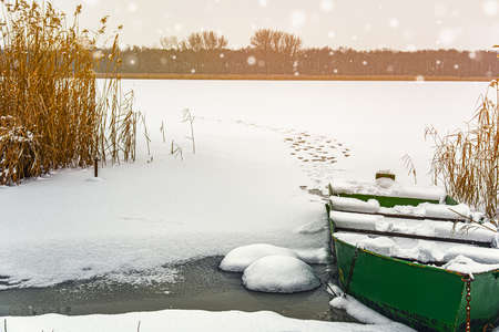 Winter Landscape with a fishing boatの写真素材