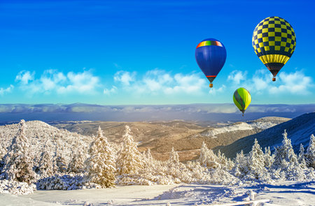 a balloon flies against the sky. winter landscape from a height ofの写真素材