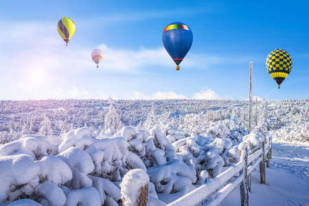 a balloon flies against the sky. winter landscape from a height ofの写真素材