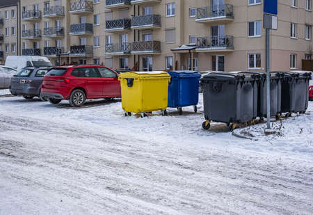 A row of colorful dustbins for waste segregation. streets of the city in Winter
