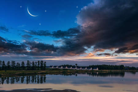 Crescent moon with beautiful sunset background. bright skyの写真素材