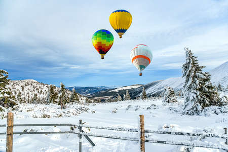 balloon flies into the sky, winter landscape from a height ofの写真素材