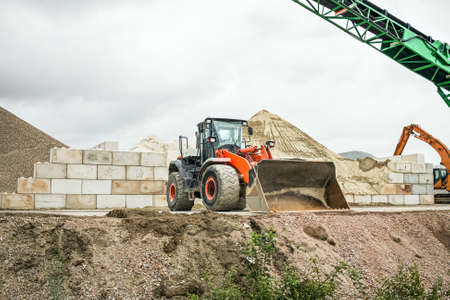 Excavator-loader on the repair section of the street