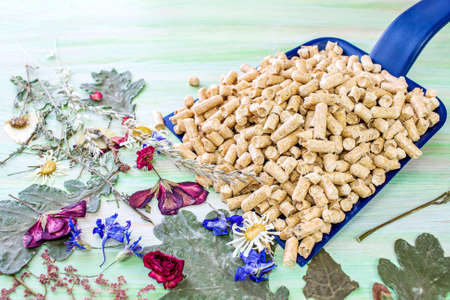 Wooden pellets on a wooden background, eco-friendly product
