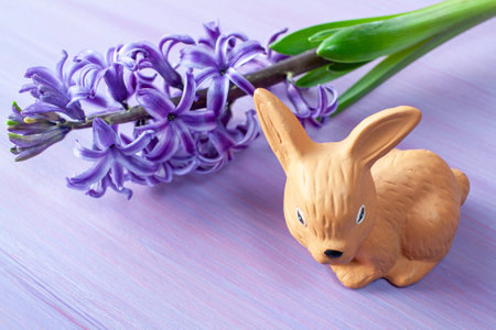 Easter hare on a floral background. Purple hyacinth on the tableの写真素材