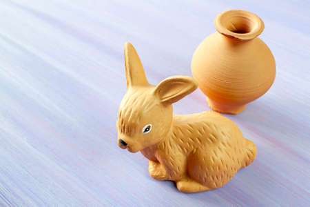 Old handmade pottery from macedonia. jug and hare made of clay, on a wooden background