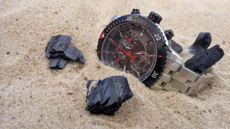 Tissot chronograph in sand and water on the beach, Krasnodar, Russia-13.06.2020.のeditorial素材