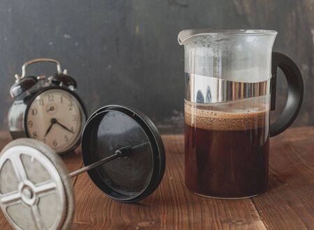 Morning fresh coffee. Wake up with an alarm clock. A stimulating drink. Black and aromatic. The smell of freshly ground coffee.の写真素材