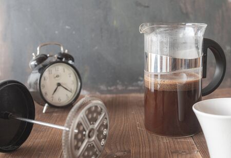 Morning fresh coffee. Wake up with an alarm clock. A stimulating drink. Black and aromatic. The smell of freshly ground coffee.の写真素材