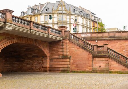Historic tenement house in Frankfurt. Crossing the street. A small viaduct. Historical object. Stone stairs and balustrades.の写真素材