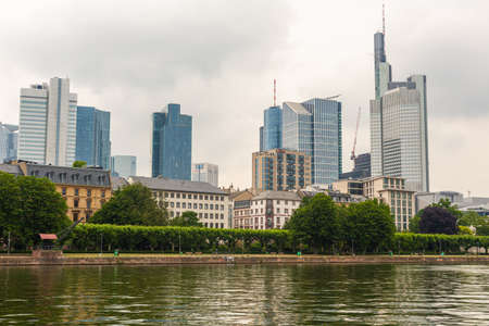 Skyscrapers on the Main in Frankfurt. Glass buildings. A city in Europe. Calm river. Old and new buildings. City development. Modern Architecture.のeditorial素材