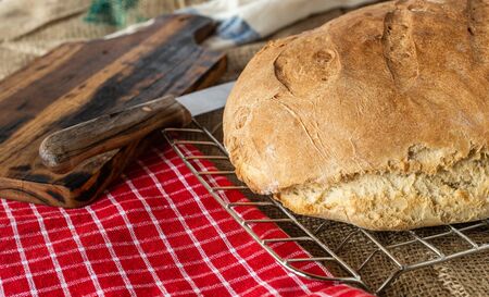 Homemade bread. Homemade pastries. Breads on the kitchen table. Tasty and healthy. Fresh bread for vegetarians. Bread with wheat flour.の写真素材