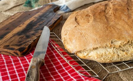 Homemade bread. Homemade pastries. Breads on the kitchen table. Tasty and healthy. Fresh bread for vegetarians. Bread with wheat flour.の写真素材