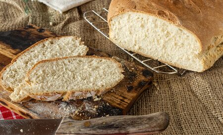 Homemade bread. Homemade pastries. Breads on the kitchen table. Tasty and healthy. Fresh bread for vegetarians. Bread with wheat flour.の写真素材