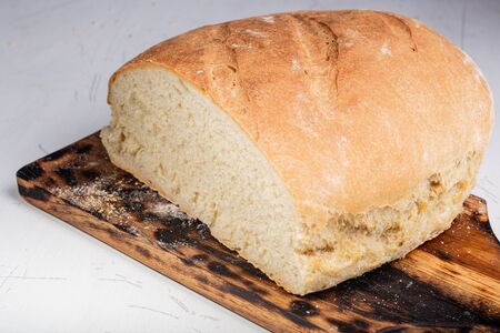 Homemade bread. A whole loaf of bread. Bread with wheat flour. Homemade pastries. Smash and healthy. Family bakery.の写真素材