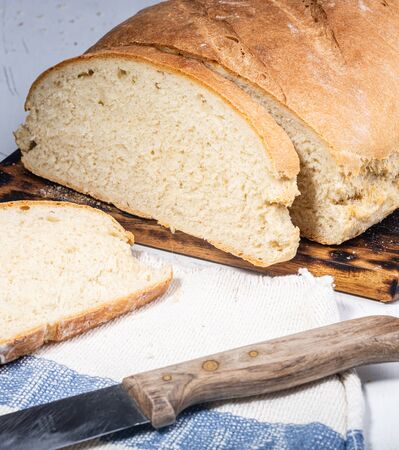 Homemade bread. A whole loaf of bread. Bread with wheat flour. Homemade pastries. Smash and healthy. Family bakery.の写真素材