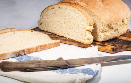 Homemade bread. A whole loaf of bread. Bread with wheat flour. Homemade pastries. Smash and healthy. Family bakery.の写真素材