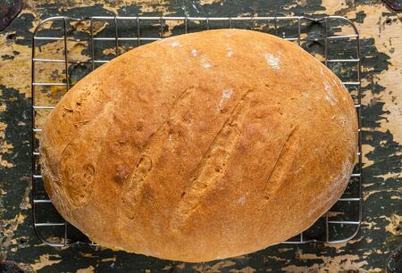 Homemade bread. A whole loaf of bread. Bread with wheat flour. Homemade pastries. Smash and healthy. Family bakery.の写真素材