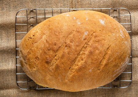 Homemade bread. A whole loaf of bread. Bread with wheat flour. Homemade pastries. Smash and healthy. Family bakery.の写真素材