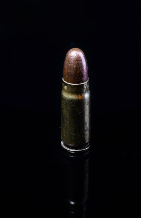 Pistol bullet. Metal case. Cartridge on a black background. Isolated from background.の写真素材