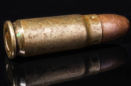 Pistol bullet. Metal case. Cartridge on a black background. Isolated from background.の写真素材