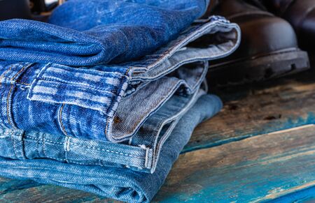 Blue jeans and work boots. Practical work clothes. Placed on boards.の写真素材