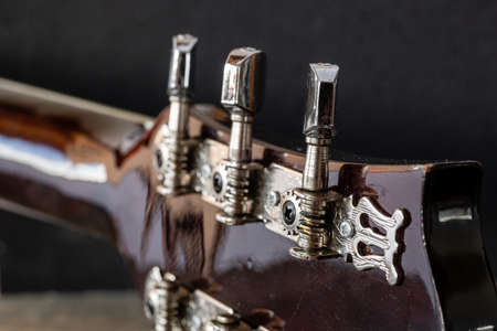 Old guitar keys. Musical equipment macro photo. Metal strings Acoustic guitar.の写真素材