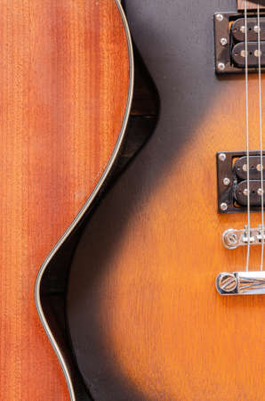 Electric guitar body. Music equipment on old boards. Two humbuckers. Wooden body. Metal stringsの写真素材