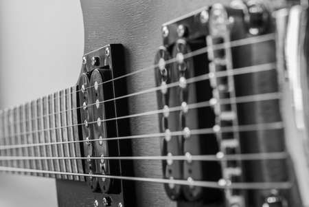 Electric guitar body. Music equipment on old boards. Two humbuckers. Photo of a black and white guitar.の写真素材