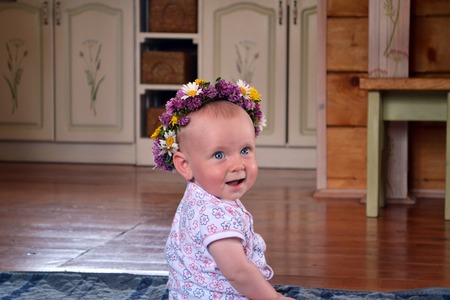 Smiling baby with flowers wreathの写真素材
