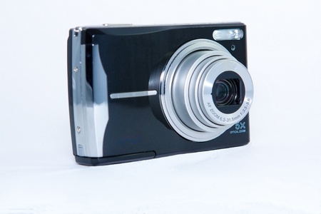 A black digital camera isolated against a white background