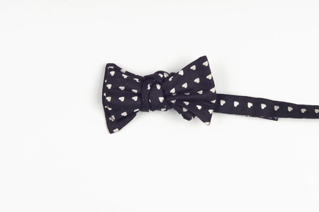  nice black bow-tie, marked with form of little hearts, excellent fitted white shirt. Isolated on white backgroundの写真素材