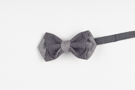 an elegant grey bow-tie helps to feel yourself positive in any company. Isolated on white backgroundの写真素材