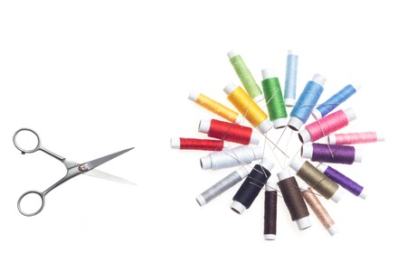 Pair of scissors is the irreplaceable thing for sewing or embroidery  Nice flower of threads with many little needles on background  Horizontal photo の写真素材