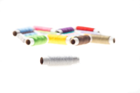 Selected focus on the nice white thread  Interesting pattern of many-colored threads on background 