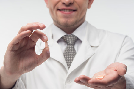 Selected focus on the wonder-working pills in the hands of the doctorの写真素材
