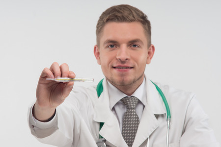 Selected focus on the thermometer, which is kept by the doctor 
