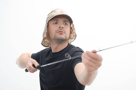 Half-length portrait of young fisherman concentrated on his hobby  Isolated on white backgroundの写真素材