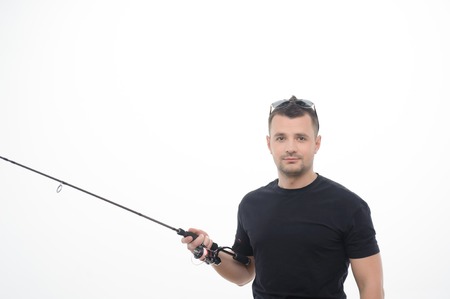 Half-length portrait of handsome fisherman wearing nice black T-shirt and looking at us with concentration  Isolated on white backgroundの写真素材