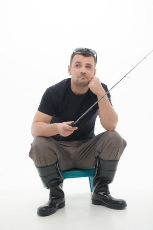 Handsome young fisherman sitting and fish thinking about the biggest caught he had  Isolated on...
