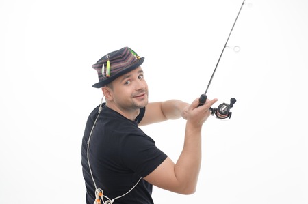  Half-length portrait of smiling fisherman standing sideways and throwing his fishing rod  Isolated on white backgroundの写真素材