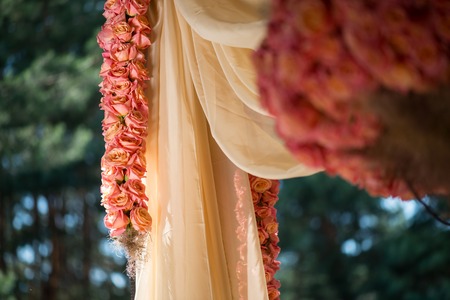 Very beautiful ornament made of roses hanging down on background of forest