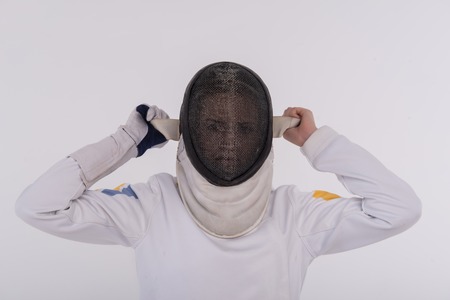 Half-length portrait of woman wearing white fencing costume and black wanted to take off her fencing...