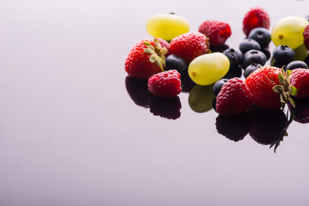 A heap of tempting delicious fruits lying on the white backgroundの写真素材