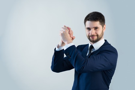 Half-length portrait of handsome young bearded happy man wearing white shirt tie and blue jacket satisfied with the successful interview. Isolated on white backgroundの写真素材