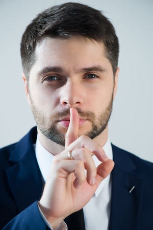 Half-length portrait of handsome young bearded man wearing white shirt tie and blue jacket wanted we keep calm. Isolated on white backgroundの写真素材
